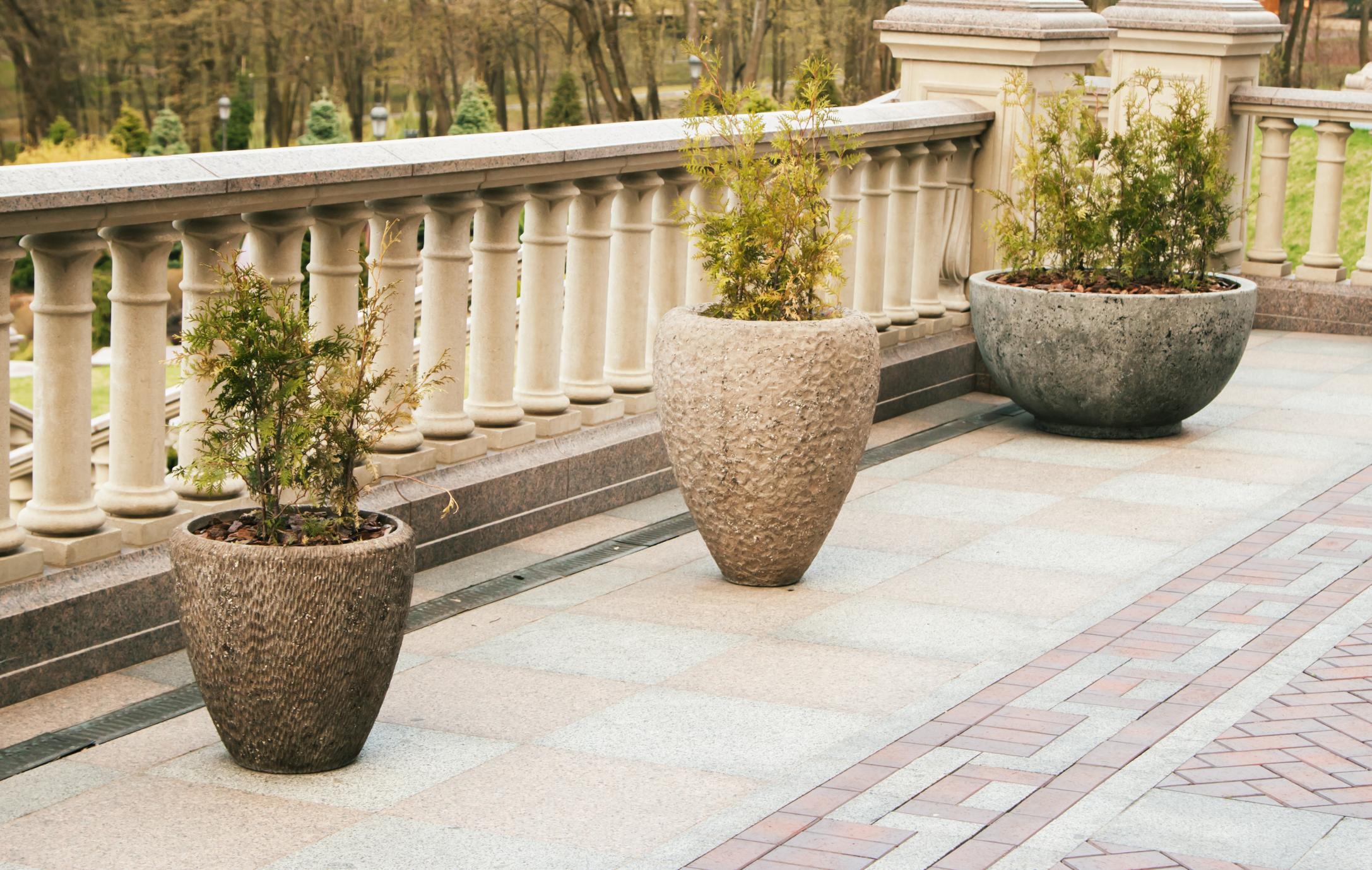 a concrete veranda with plant vases